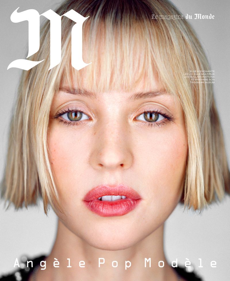 Close-up portrait of Angèle Pop Modèle on a magazine cover with an 'M' logo, shot in a photo studio with bright lighting and a neutral backdrop.