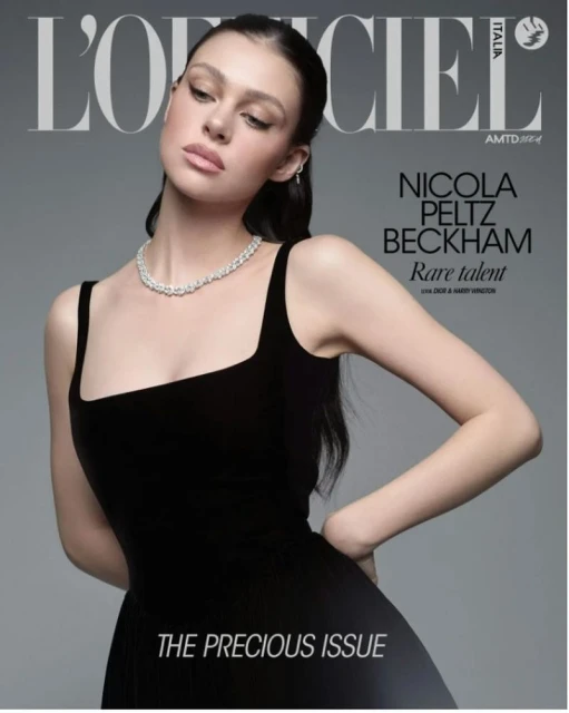 Magazine cover featuring Nicola Peltz Beckham in a black dress and diamond necklace, posing against a grey backdrop with magazine text.
