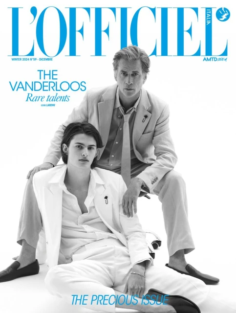 L'Officiel Italia magazine cover featuring two male models in light suits against a stark white backdrop, highlighting fashion and style.