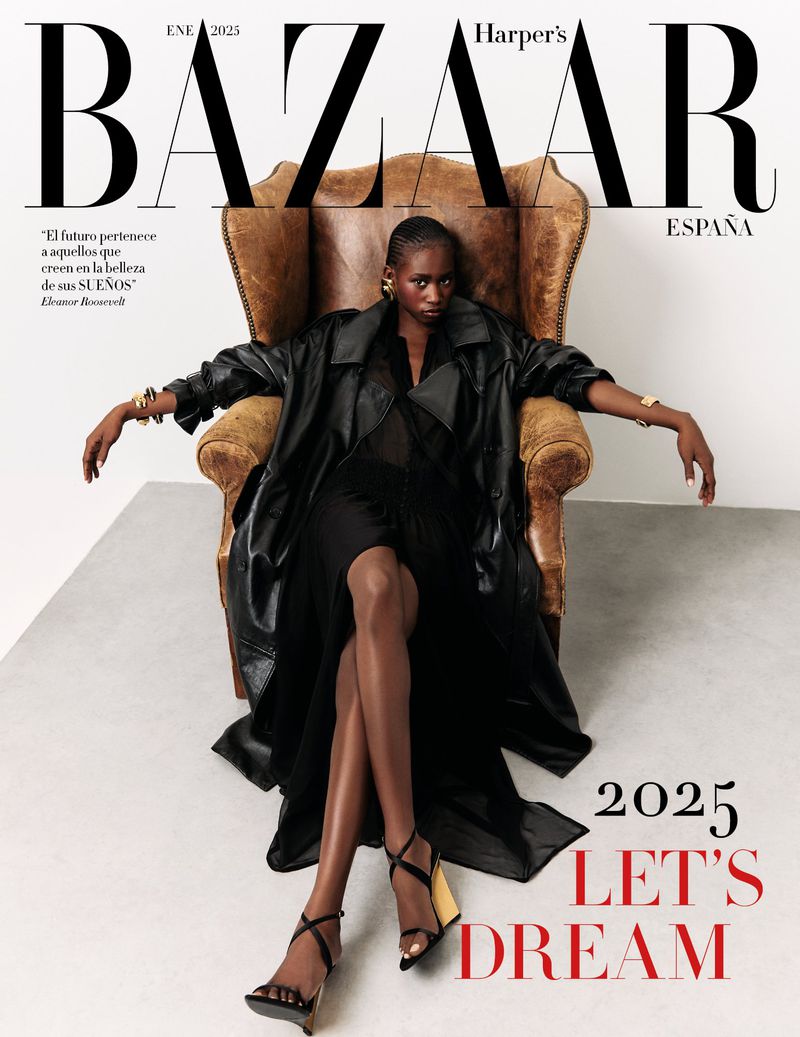 Harper's Bazaar Espana cover featuring a woman in a black dress and coat posing in a chair, complemented by text and a white backdrop.