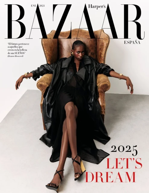 Harper's Bazaar Espana cover featuring a woman in a black dress and coat posing in a chair, complemented by text and a white backdrop.