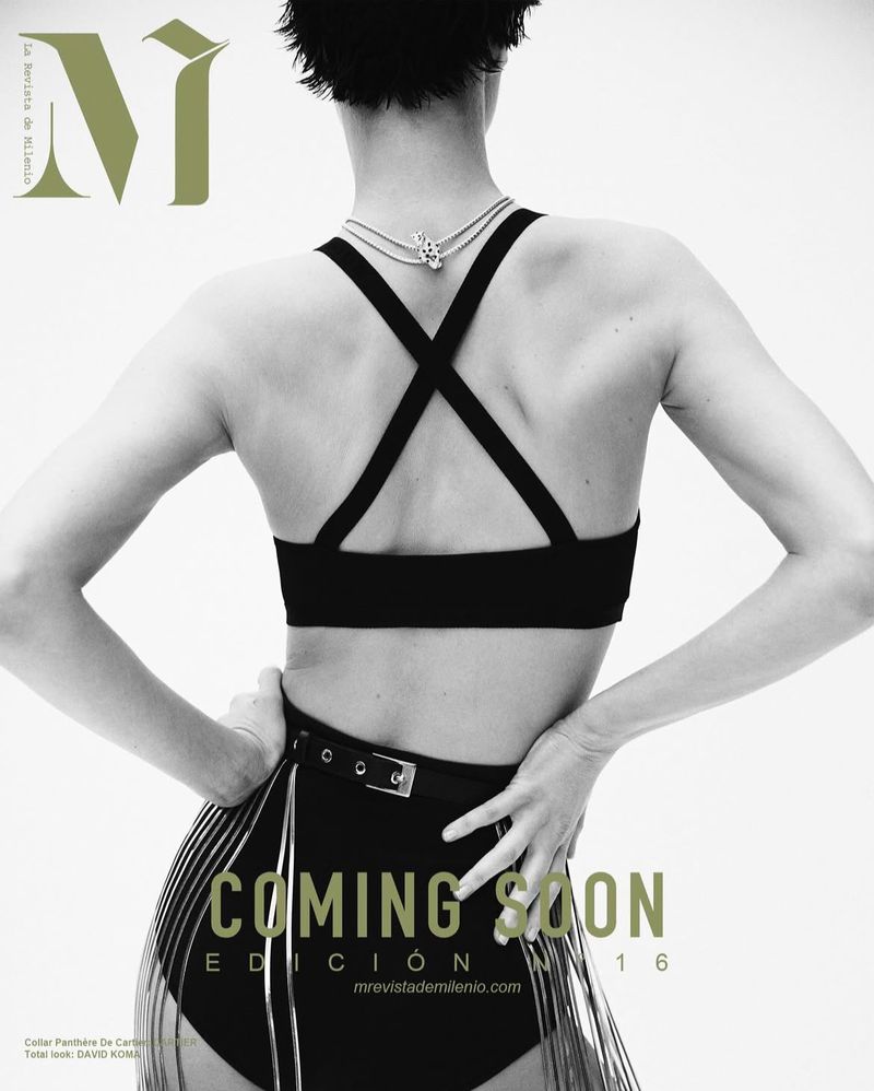 Fashion magazine cover featuring a woman from behind wearing a black outfit and jewelry, against a clean white backdrop.