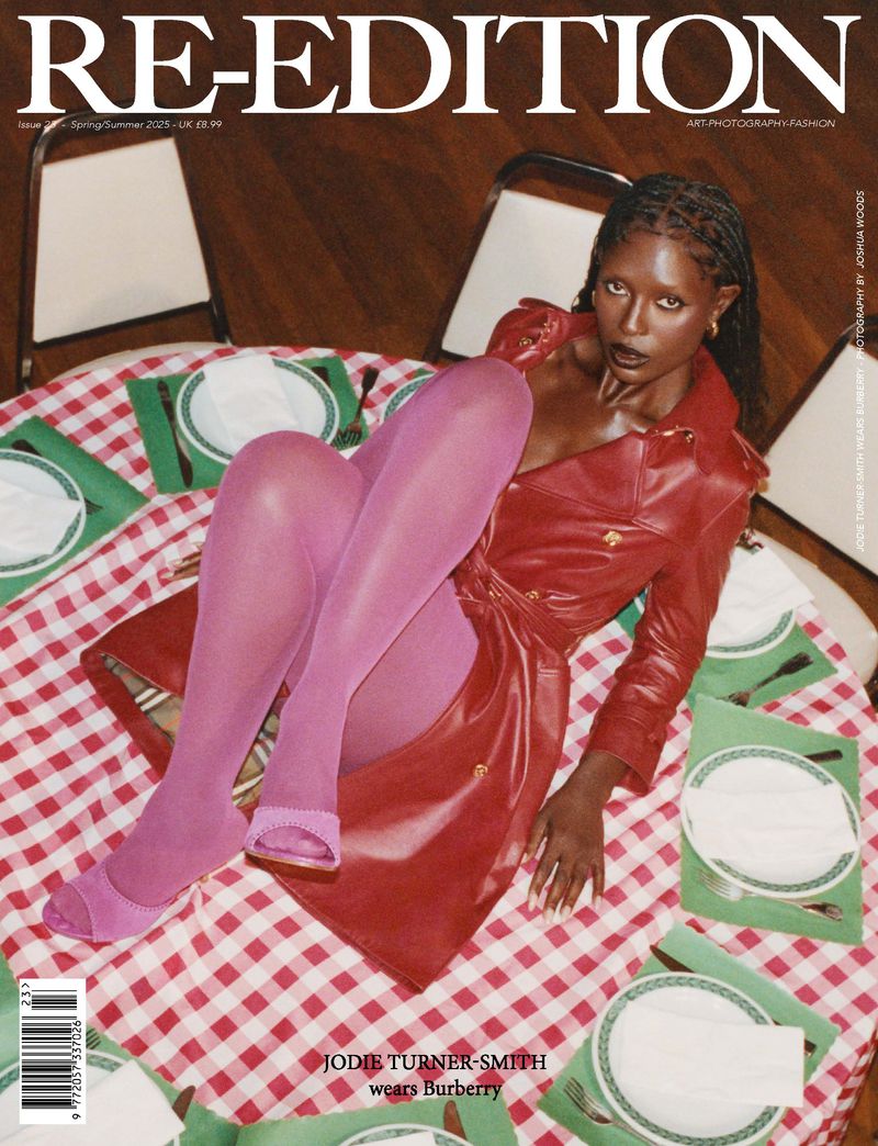 Magazine cover featuring Jodie Turner-Smith in a red coat and pink tights lying on a picnic blanket with dining placements.