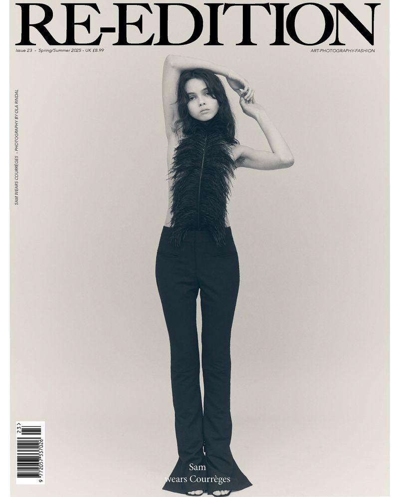 Magazine cover featuring a woman in feathered top and black pants posing against a neutral backdrop with the magazine's title 'RE-EDITION'.