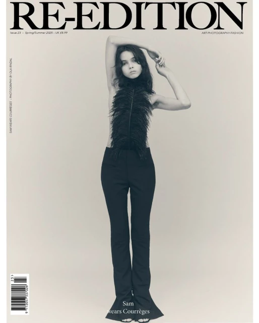 Magazine cover featuring a woman in feathered top and black pants posing against a neutral backdrop with the magazine's title 'RE-EDITION'.