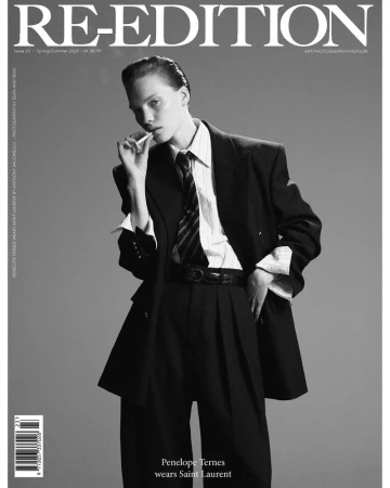 Black and white fashion magazine cover featuring a young woman in an oversized suit, with text reading 'RE-EDITION' at the top.