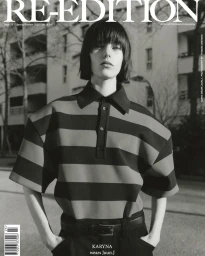 Monochrome magazine cover featuring a model with short dark hair in a striped polo shirt against residential buildings
