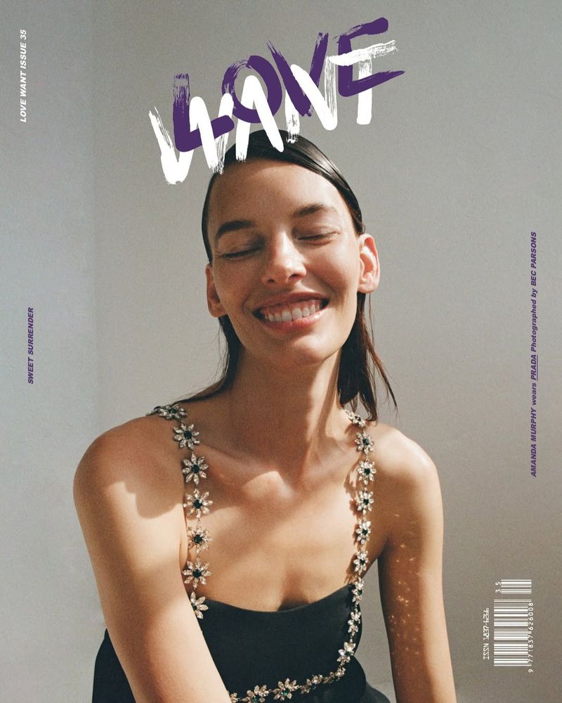 Magazine cover featuring a smiling woman with wet hair and a black dress with floral straps against a light gray background.