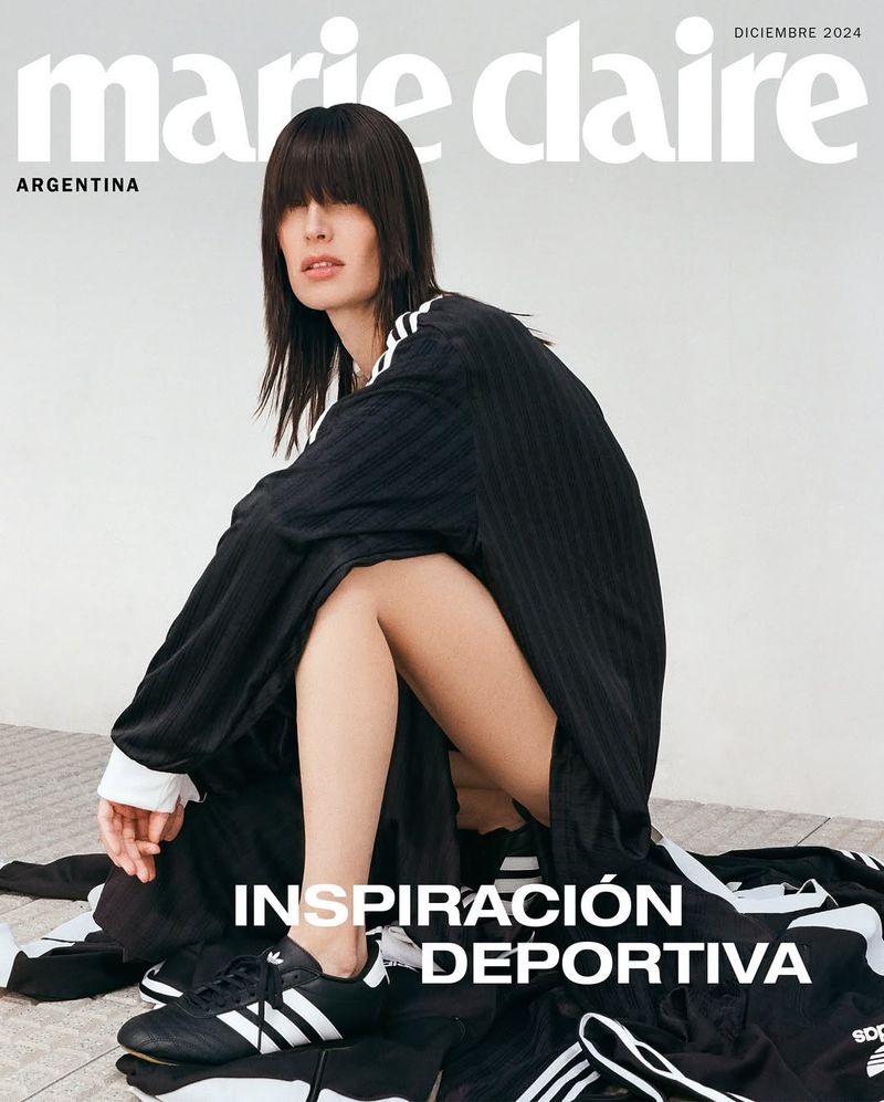 Marie Claire Argentina cover featuring a fashion model in an Adidas tracksuit squatting against a neutral backdrop wearing athletic shoes.