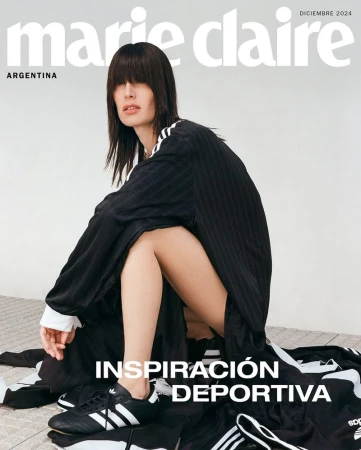 Marie Claire Argentina cover featuring a fashion model in an Adidas tracksuit squatting against a neutral backdrop wearing athletic shoes.