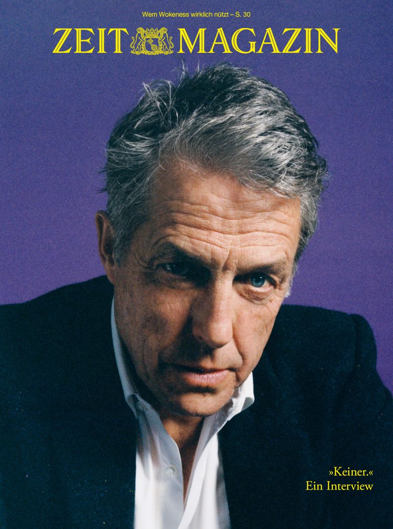 Magazine cover featuring an older adult man with gray hair, wearing a suit and tie, posing against a purple background with title text.