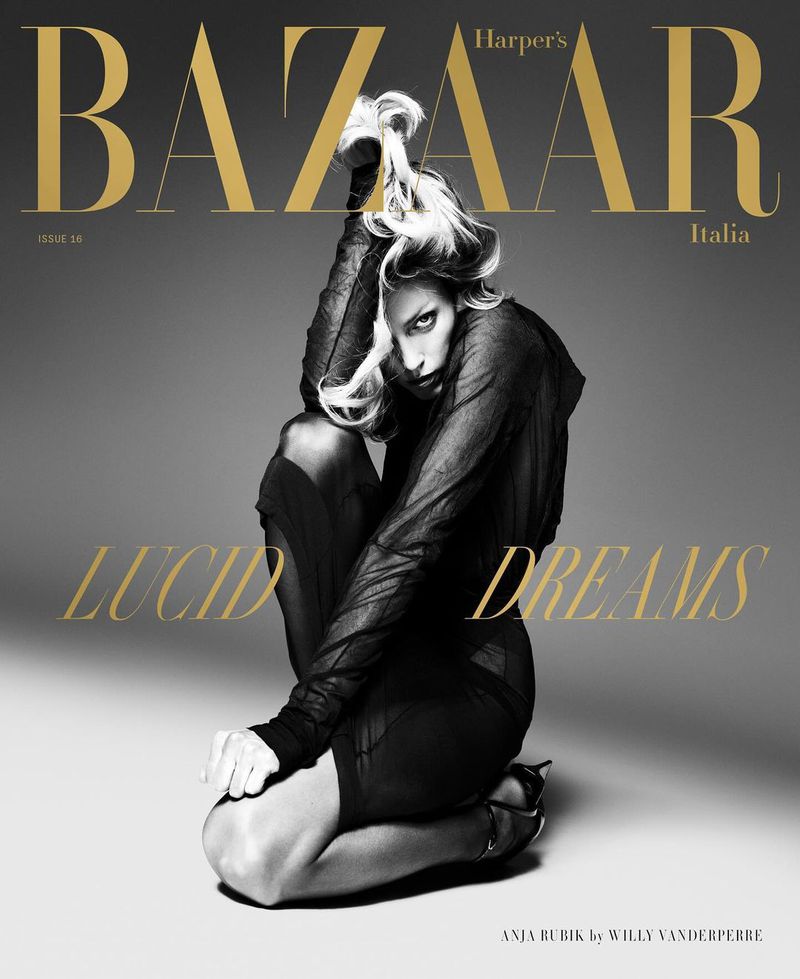 Harper's Bazaar Italia cover featuring a model with blonde hair in dark clothing, kneeling in a studio setting with gold text overlay.