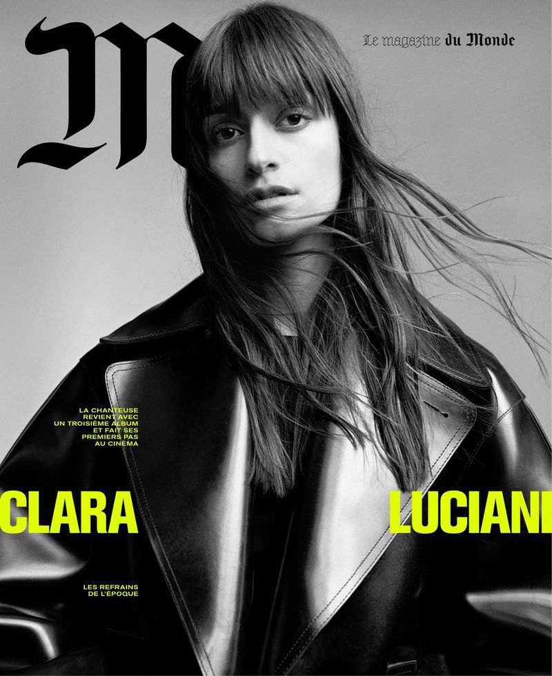 Black and white magazine cover featuring a woman with bangs wearing a black trench coat, with Clara Luciani displayed in yellow text.