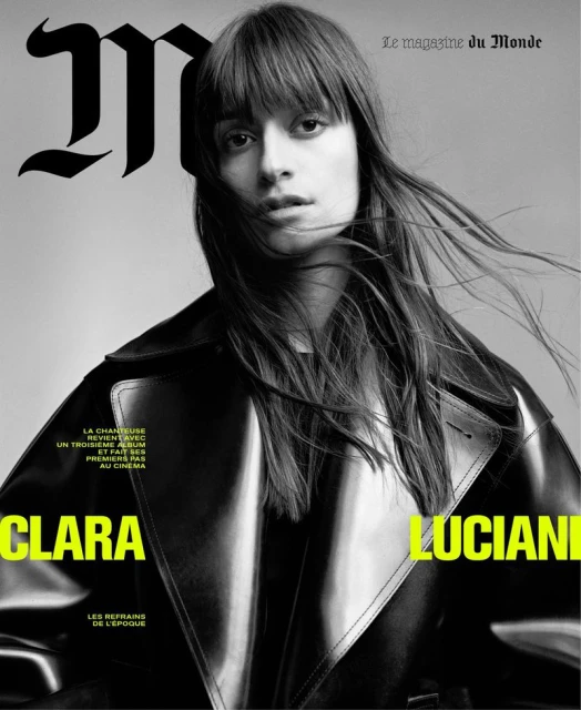 Black and white magazine cover featuring a woman with bangs wearing a black trench coat, with Clara Luciani displayed in yellow text.