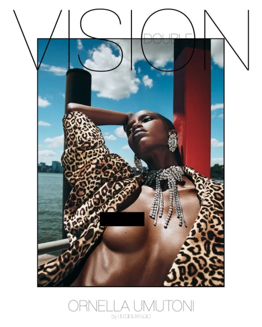 Editorial fashion shot featuring an African woman in a leopard-print jacket and jeweled necklace against a sky and water background.