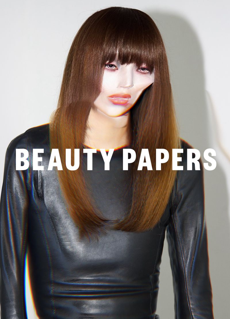 Beauty Papers magazine cover featuring a model with brown hair and a black leather top against a white background. Bold, white text overlay.