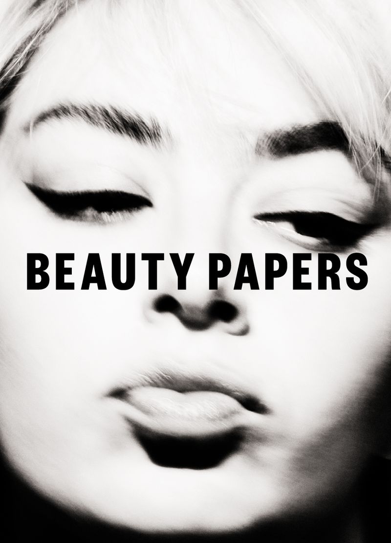 Close-up beauty portrait featuring a woman with blond hair, closed eyes, and dark eyeliner, complemented by the prominent text "BEAUTY PAPERS."