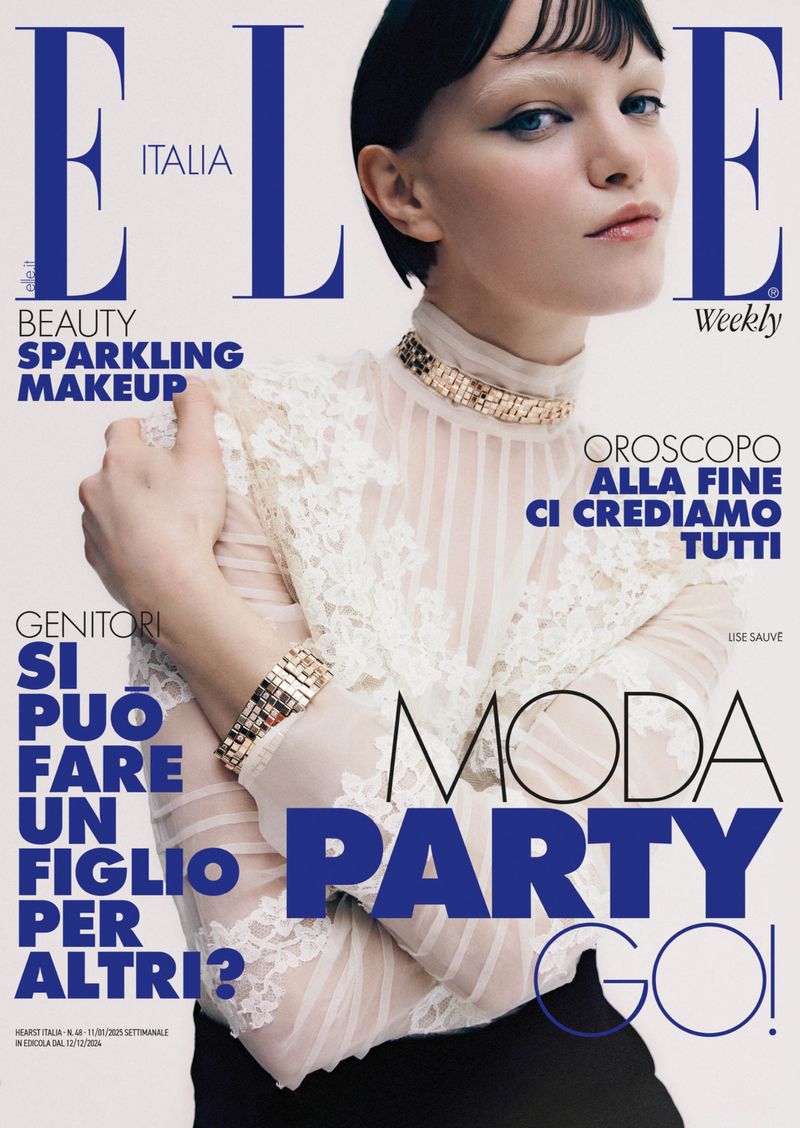 Elle Italia magazine cover featuring a model with fair skin and dark hair wearing a lace top and gold jewelry, with bold blue magazine text.