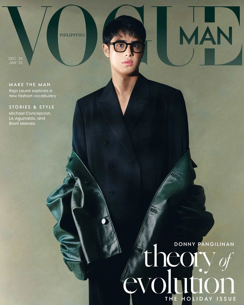 Vogue Man Philippines cover featuring a male model in a dark suit and glasses with a green jacket draped on his arm. Text overlays the image.