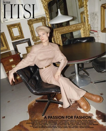 Model seated in a black office chair wearing a beige dress and beret inside an art-filled interior for HTSI magazine
