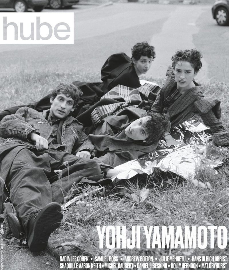 Black and white fashion editorial shot of four models lying on a blanket outdoors, wearing Yohji Yamamoto, hube magazine. 