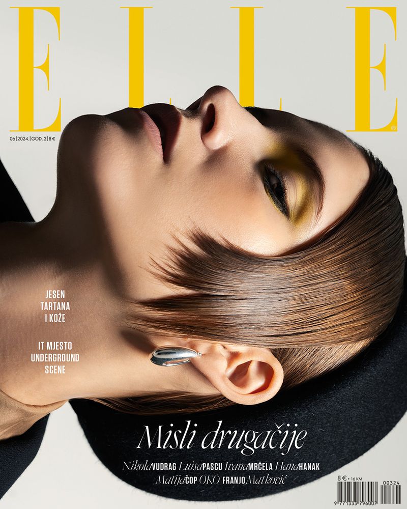 Elle magazine cover featuring a woman with striking yellow eyeshadow and sleek brown hair. The image has a minimalist, high-fashion aesthetic.