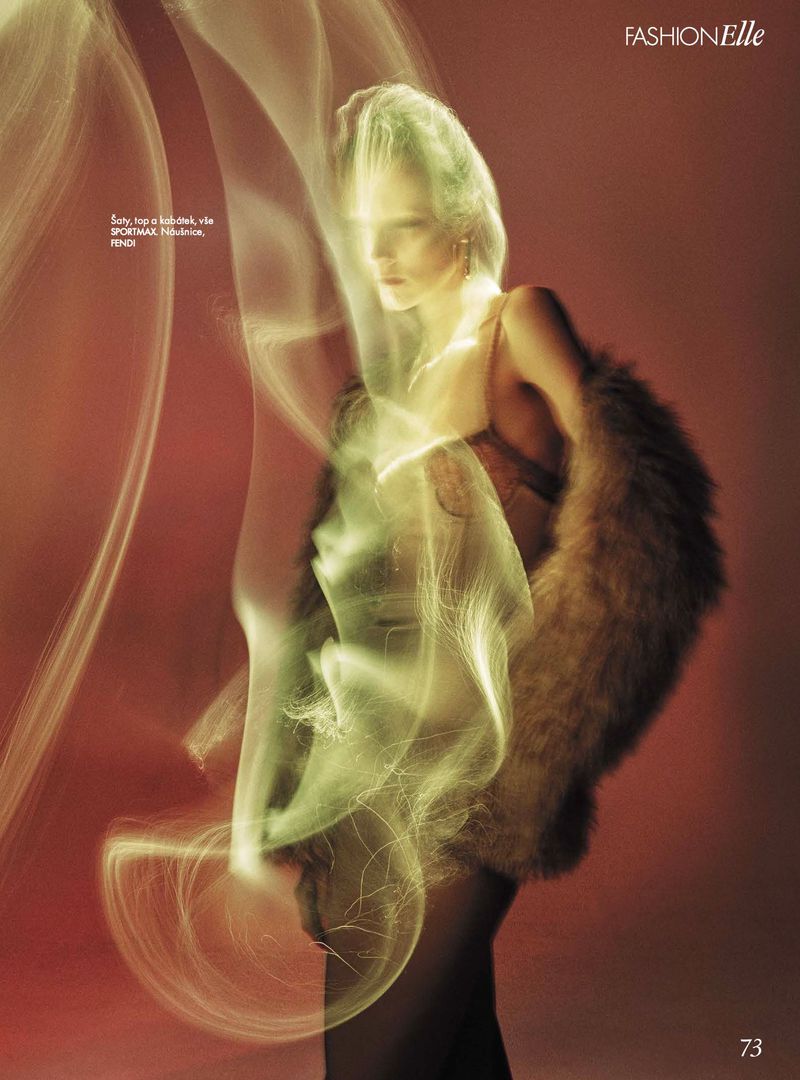 Fashion editorial shot of a woman in a fur stole with soft lighting effects and a warm color palette for a high-fashion magazine.