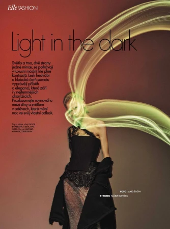 Fashion editorial featuring a woman in a black dress and dramatic green light streaks, with 'Elle Fashion' logo and magazine text.