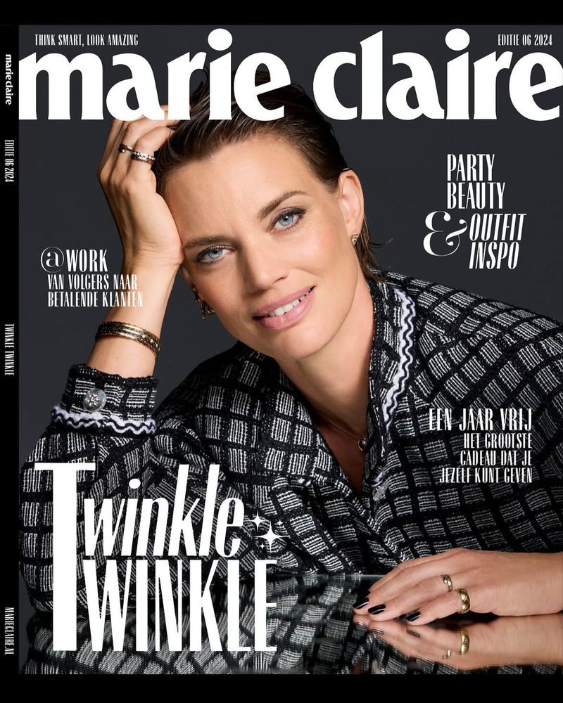 Marie Claire cover featuring an adult woman with short hair, wearing a patterned jacket and rings, against a dark gray background.