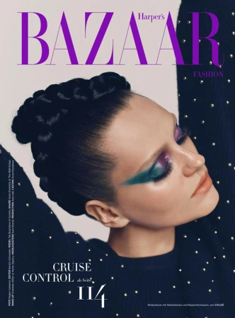 Magazine cover featuring a model with bold eye makeup and braided hair, wearing a studded top, against a neutral backdrop.