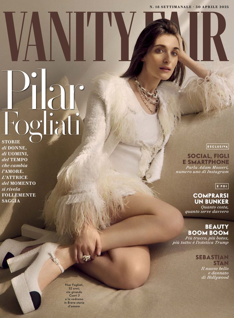 Magazine cover featuring Pilar Fogliati in a feather-trimmed jacket and heels, accessorized with layered necklaces, against a neutral backdrop.