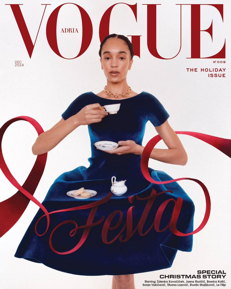 Vogue Adria cover features a female model with dark hair wearing a blue velvet dress and gold jewelry while holding a tea cup.