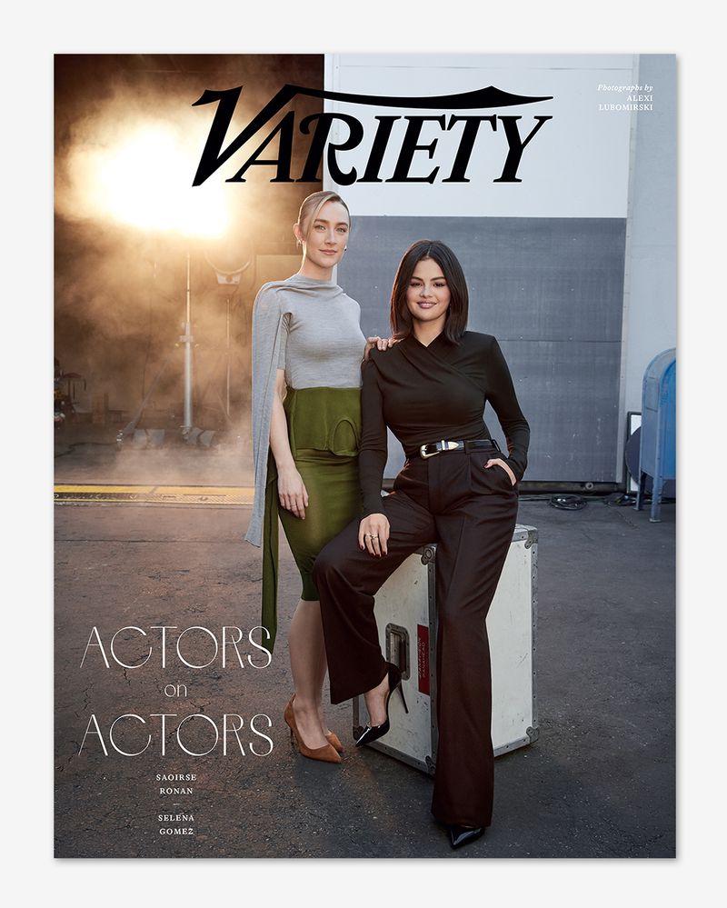 Two women, Saoirse Ronan and Selena Gomez, pose for a Variety magazine cover in a photo studio with neutral backgrounds and professional lighting.