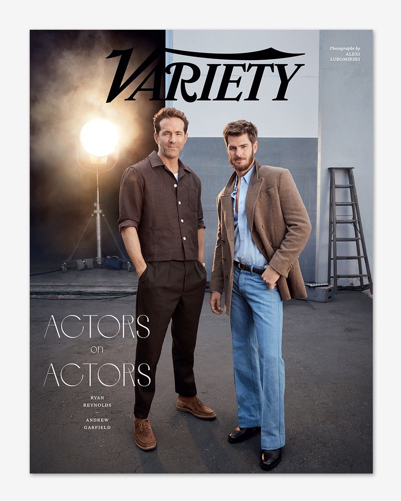 Ryan Reynolds and Andrew Garfield pose in a studio setting with a ladder and lighting equipment, featured on the cover of Variety.