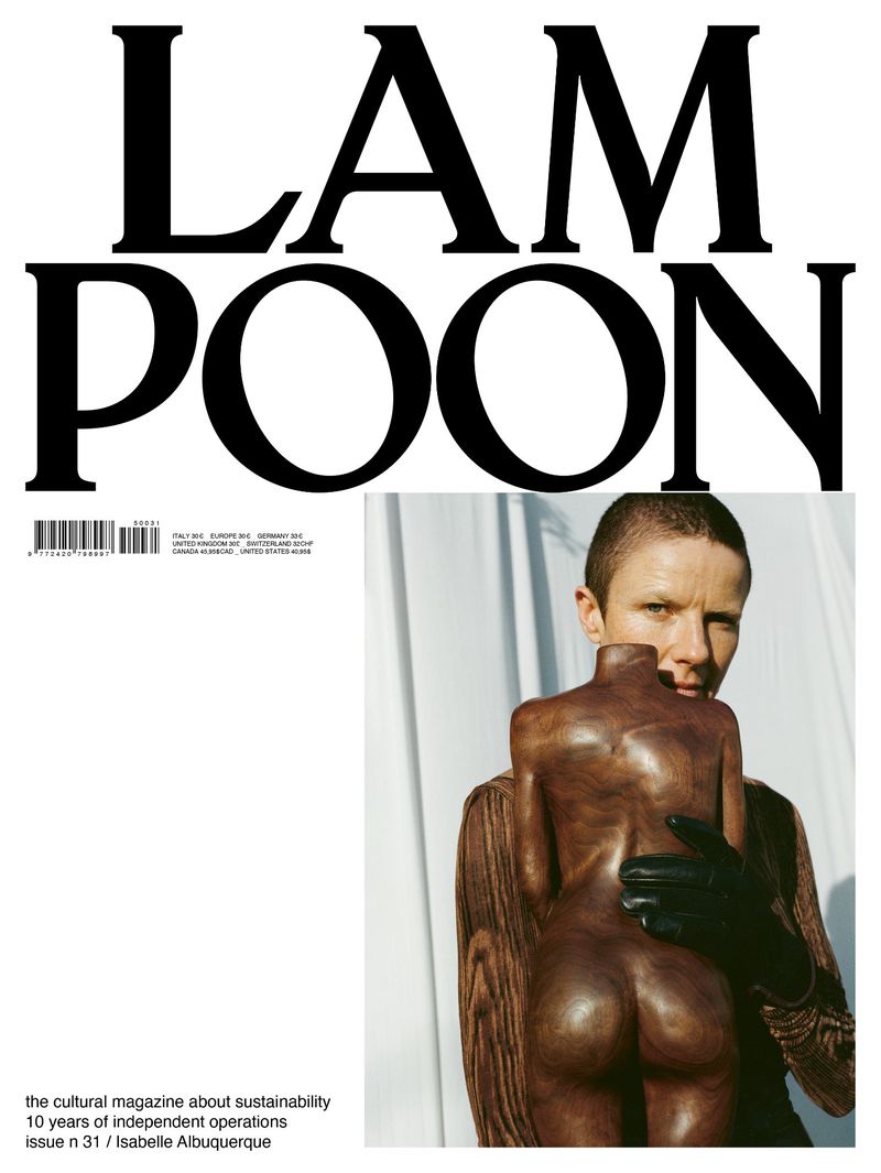 Magazine cover featuring a woman in black gloves embracing a wooden sculpture against a white backdrop, promoting sustainability in culture.