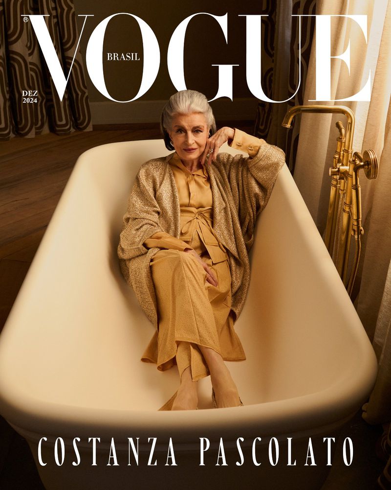 Vogue Brasil cover featuring an elderly woman in a light-yellow outfit, reclining in an ivory bathtub, captured in a studio setting.
