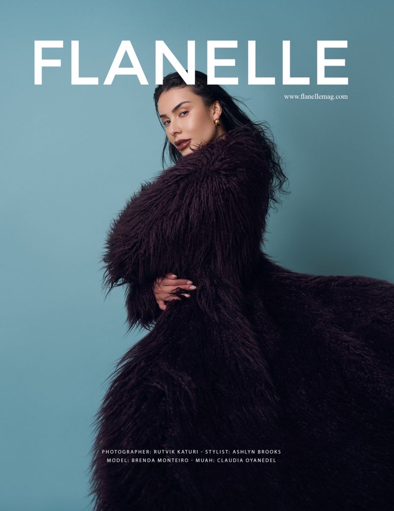 Flanelle magazine cover featuring a woman in a dark fur coat against a light blue background, with the magazine's title in white text.