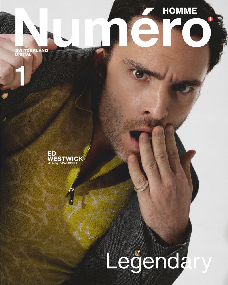 Magazine cover featuring a man with surprised expression, wearing a yellow patterned shirt and grey jacket on a white background.