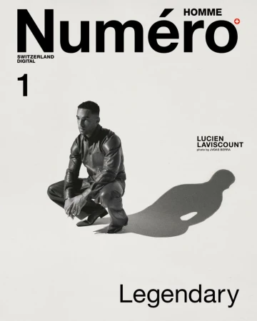 Black and white portrait of actor Lucien Laviscount crouching on white backdrop for Numero Homme Switzerland December 2024