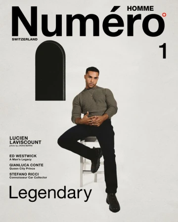 Actor Lucien Laviscount seated on a white stool against a light background for Numéro Homme Switzerland