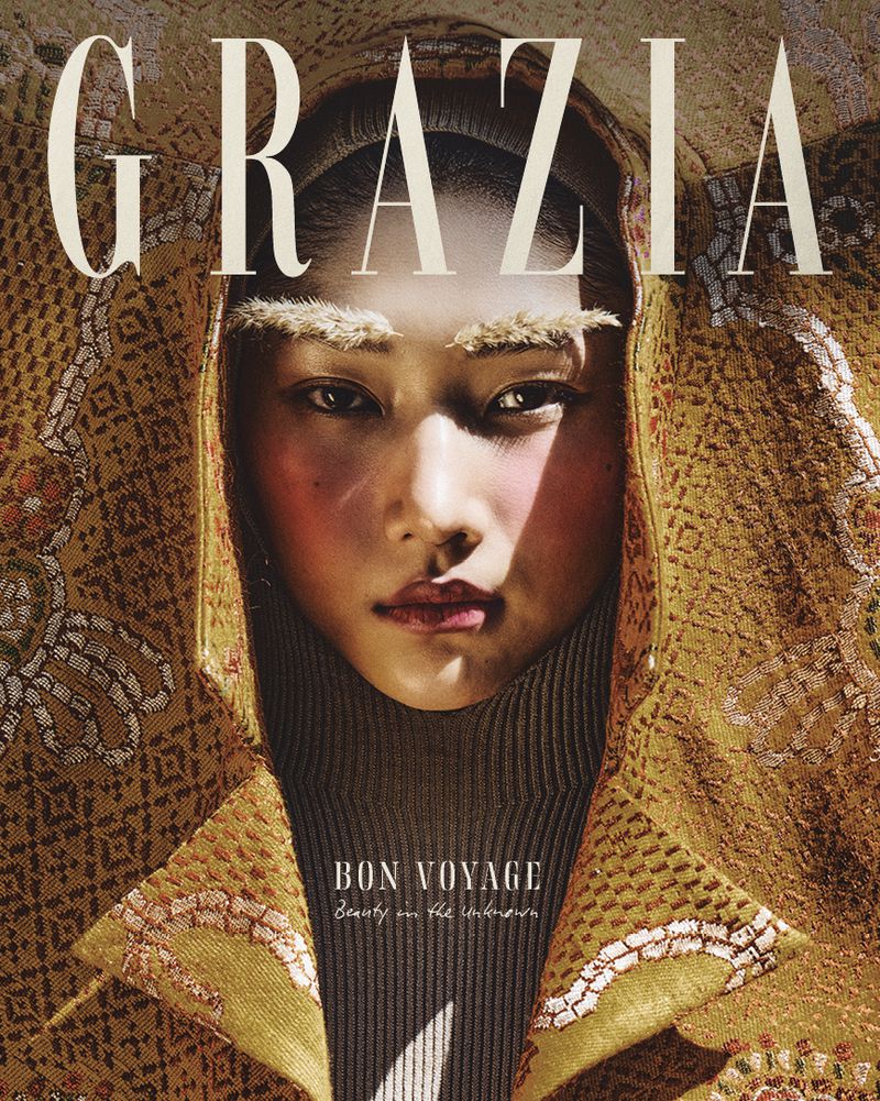 Close-up shot of an Asian woman with golden beaded garment on a fashion magazine cover with 'GRAZIA' and 'BON VOYAGE' text.