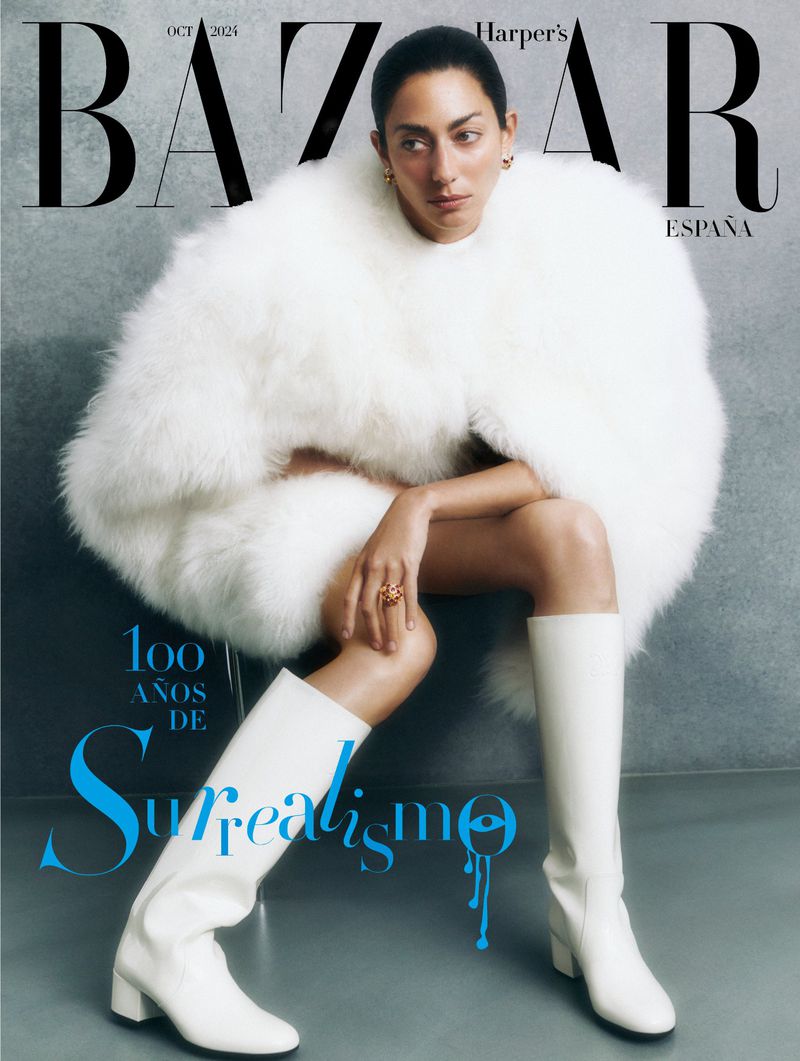 Harper's Bazaar Espana cover featuring a woman in a large white faux fur coat, white boots, and a ring. Magazine text visible.