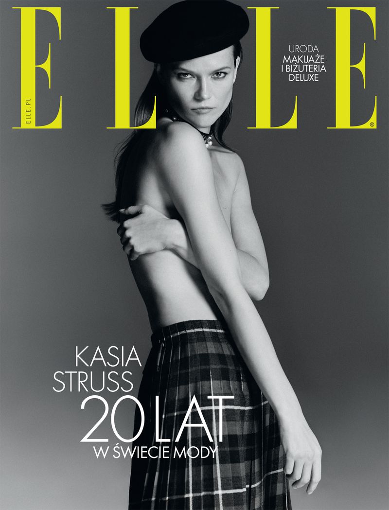 Elle magazine cover featuring a woman with bare torso and black beret, styled with a plaid skirt against a grey background.