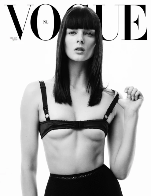 Vogue NL cover in black and white featuring a female model with blunt bangs, wearing a black bra and skirt against a bright white background.