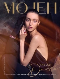 Model wearing dark evening gown with dramatic red jewellery against a moody background for Mojeh Magazine cover.
