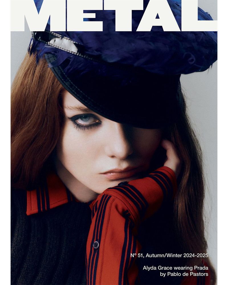 Magazine cover featuring a young woman with auburn hair, wearing a feathered cap and a striped shirt, with 'METAL' in bold white text.
