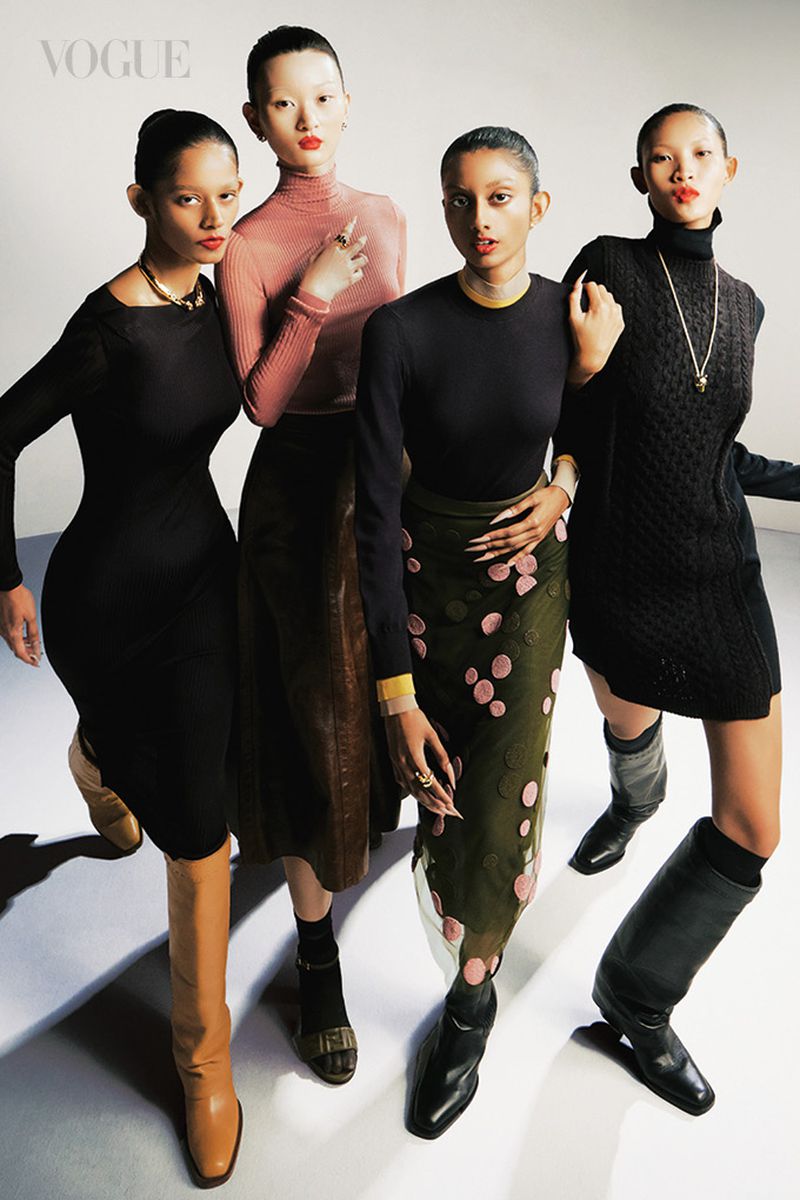 Fashion editorial shot featuring four Asian female models in stylish outfits against a white background, highlighting apparel and accessories.