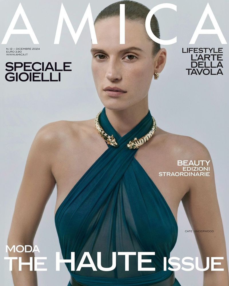 Amica magazine cover featuring a female model wearing a green dress and gold choker with animal heads against a plain background.