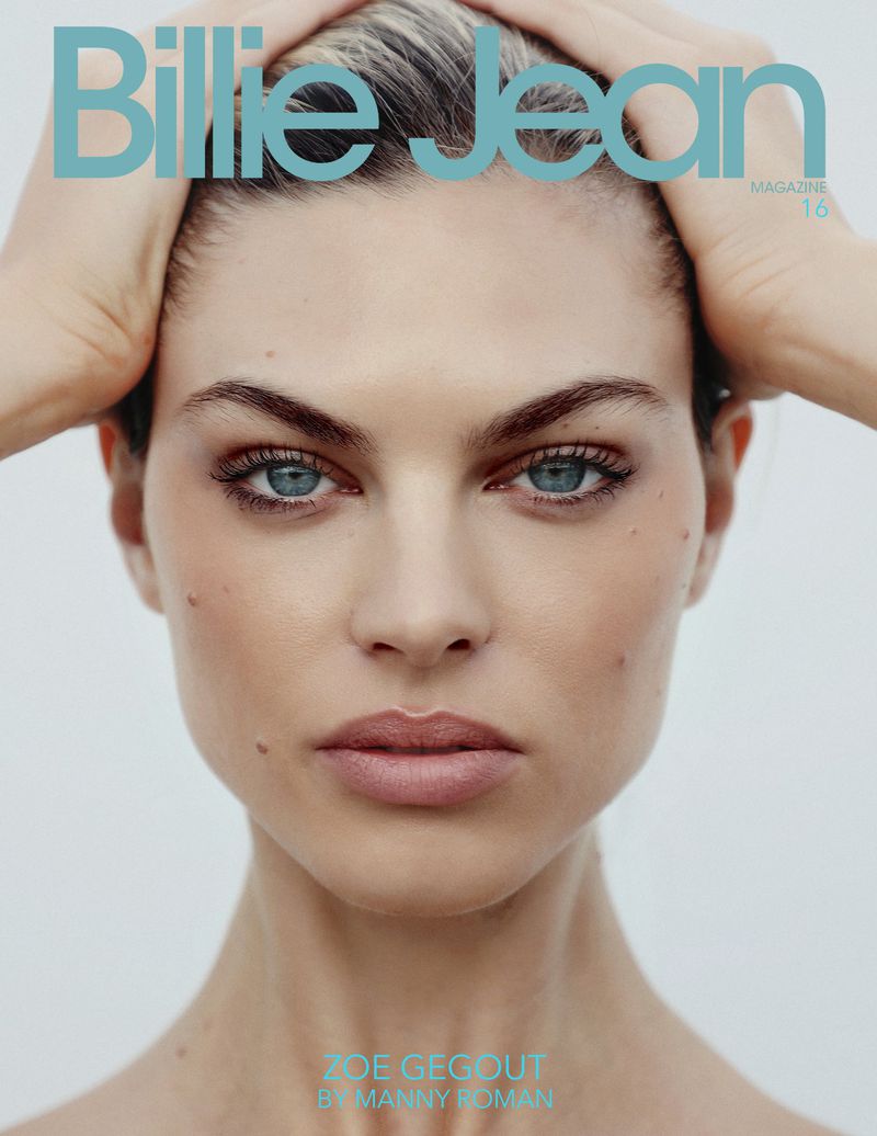 Close-up portrait of woman with blue eyes holding her hands up with 'Billie Jean Magazine 16' text on a light background.