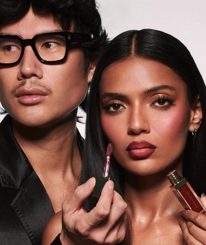 Cosmetic advertisement featuring two people: a woman with dark hair and makeup, and a man holding makeup. Beauty and fashion concept.